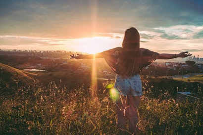 woman looking at sunrise
